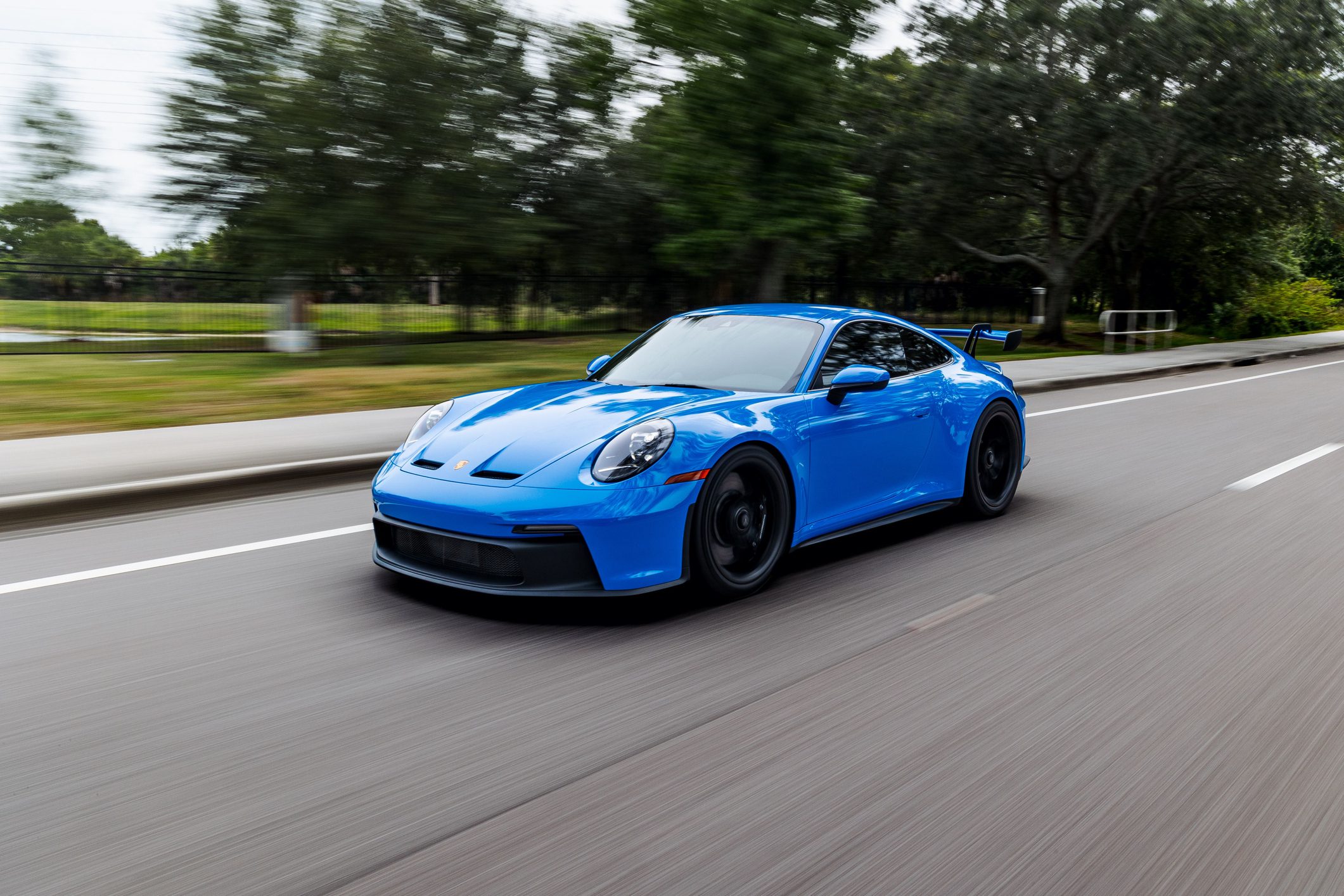 Modern blue Porsche 911 GT3 sports car in motion